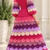 Raspberry crochet tea dress with rainbow crocodile scale skirt and balloon sleeves, back view showing colorful tiers