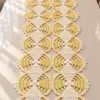 Butter yellow and ivory crocheted lace table runner with circular medallions and filet diamond appliques on white table