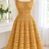 Golden honey crochet summer dress with square neckline and flared mesh skirt displayed on white mannequin